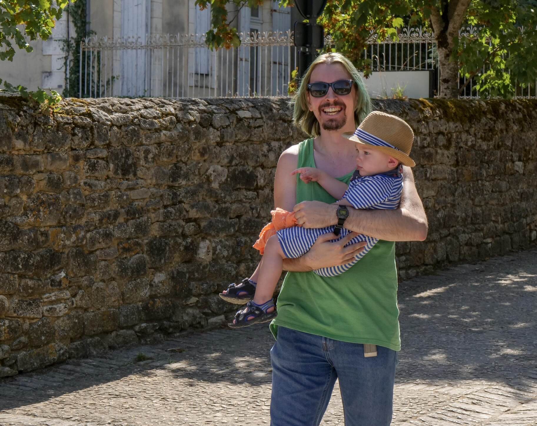 Morg smiling and holding a baby